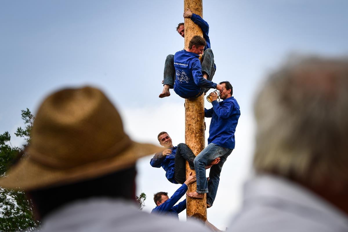 Competitors perform acrobatics on the maypole in Rottenstuben, Germany, 10 June 2019. Climbing the village’s 25-meter-high may pole has a 47-year-tradition and is said to have been started by young men looking to impress women. The competition is held in two disciplines: speed and acrobatics.